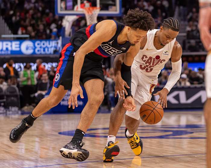 Dec 2, 2023; Detroit, Michigan, USA; Detroit Pistons guard Cade Cunningham (2) battles for the ball with Cleveland Cavaliers forward Isaac Okoro (35) during the second half at Little Caesars Arena.